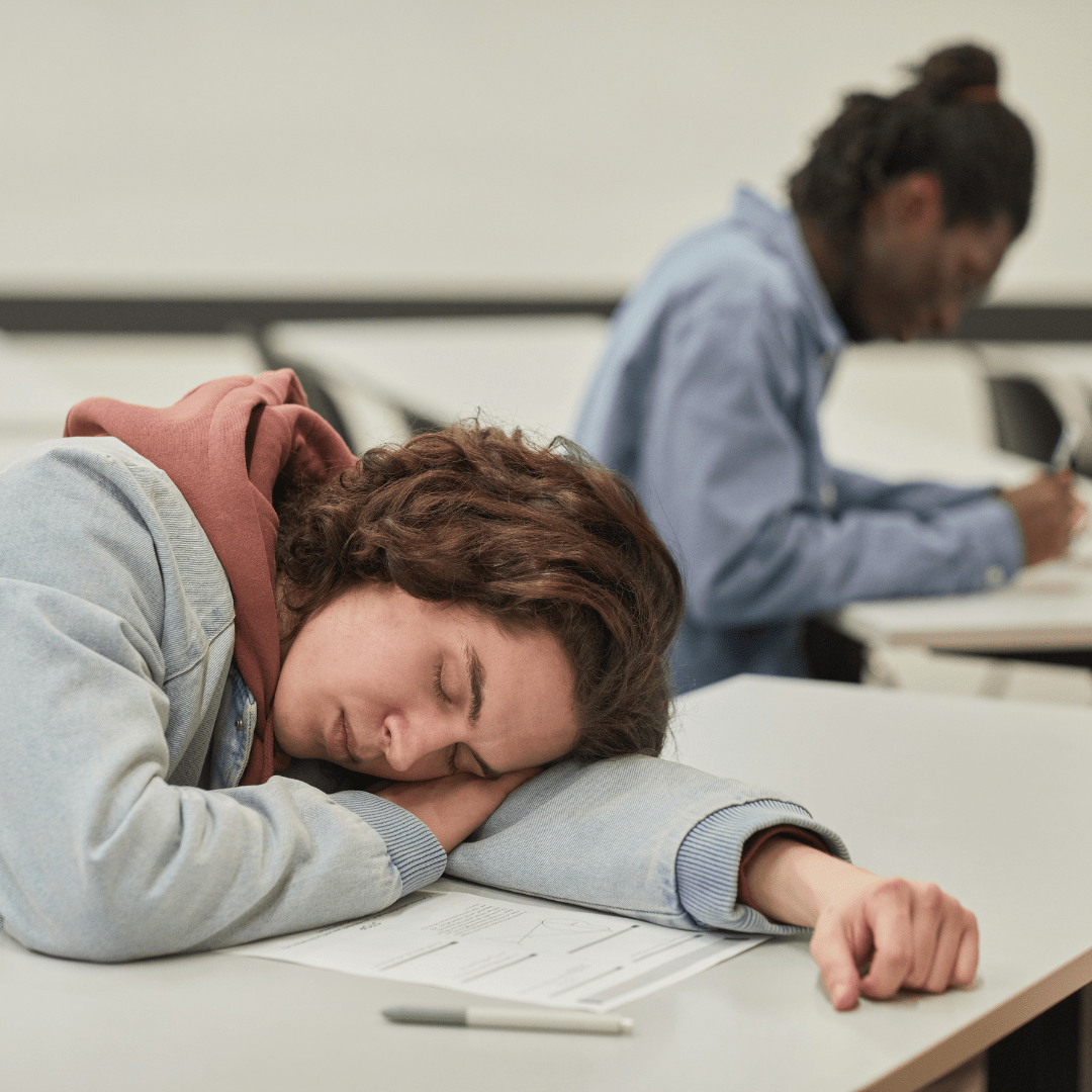 Teenager sleeping in school